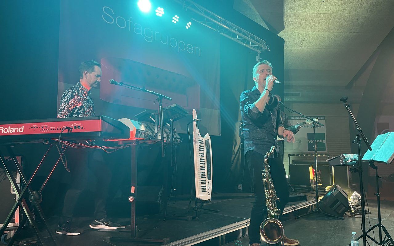 Forsanger med mikrofon, mens der spilles keyboard