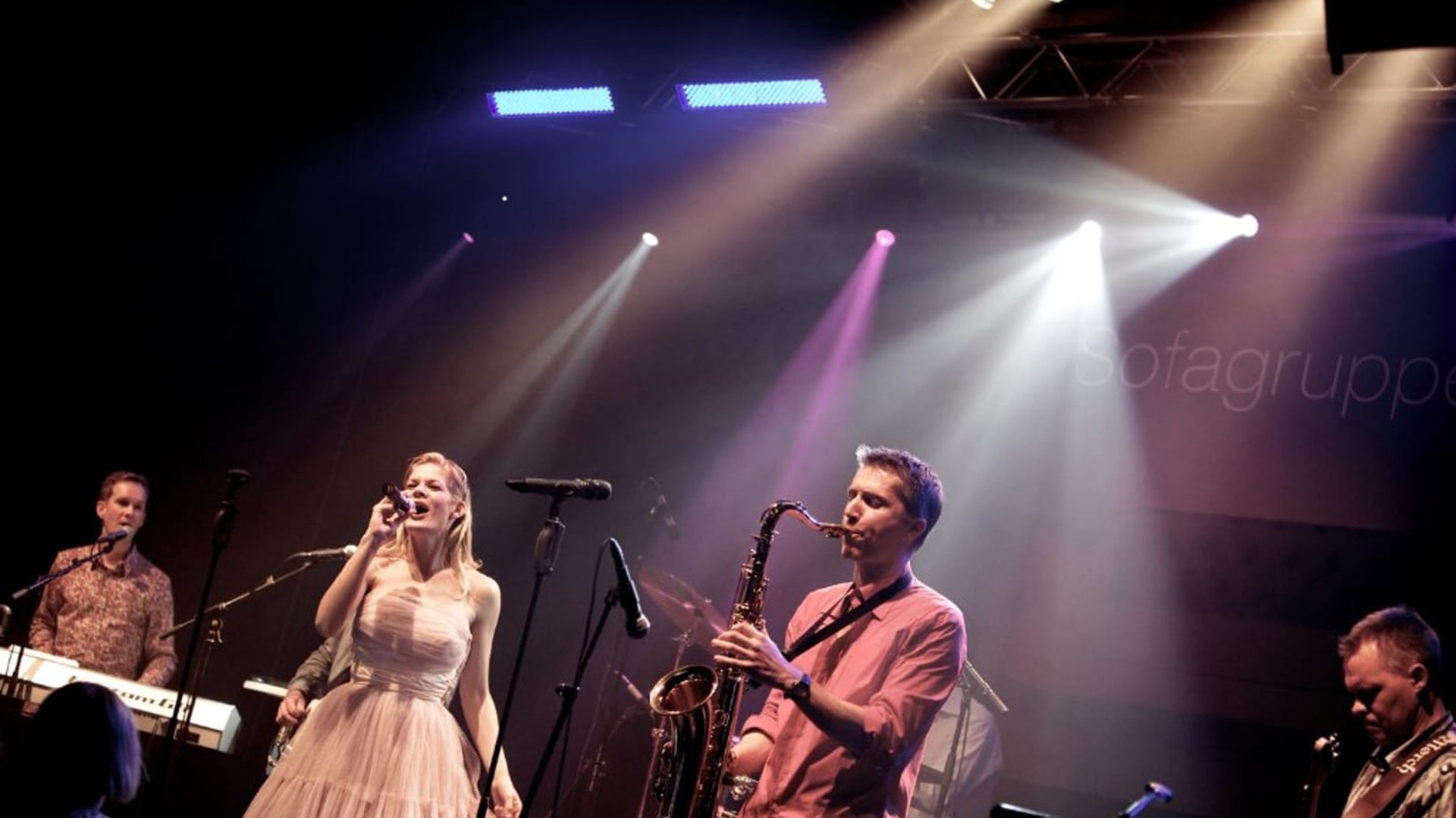 Sofagruppen på scenen med saxofon og sangerinde